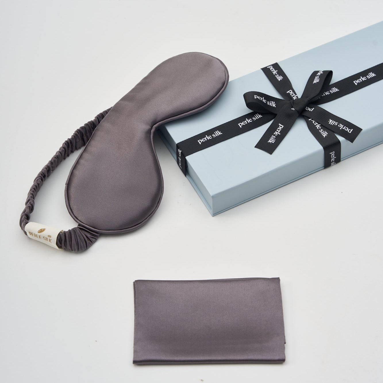 mulberry silk eye mask and pouch with a gift box on a light gray background