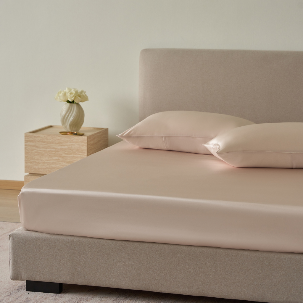 style on bed of Perle light pink fitted sheet crafted from 22 momme pure mulberry silk