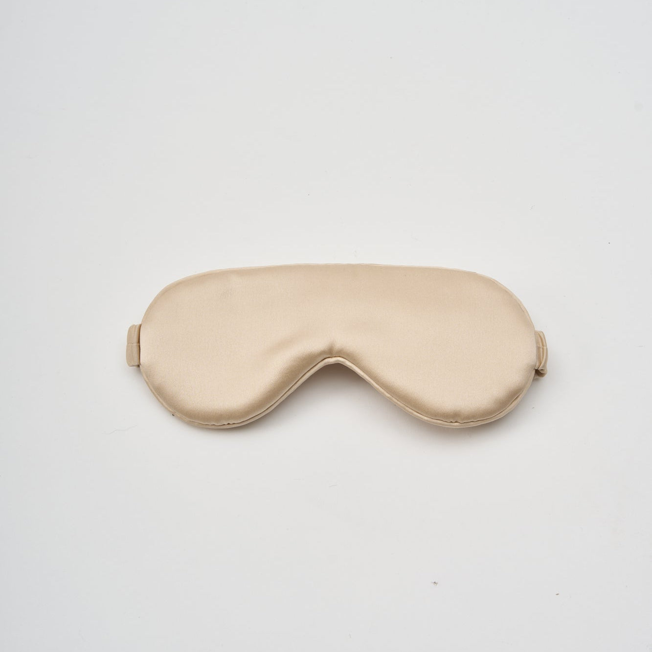 Beige sleep mask on a white background