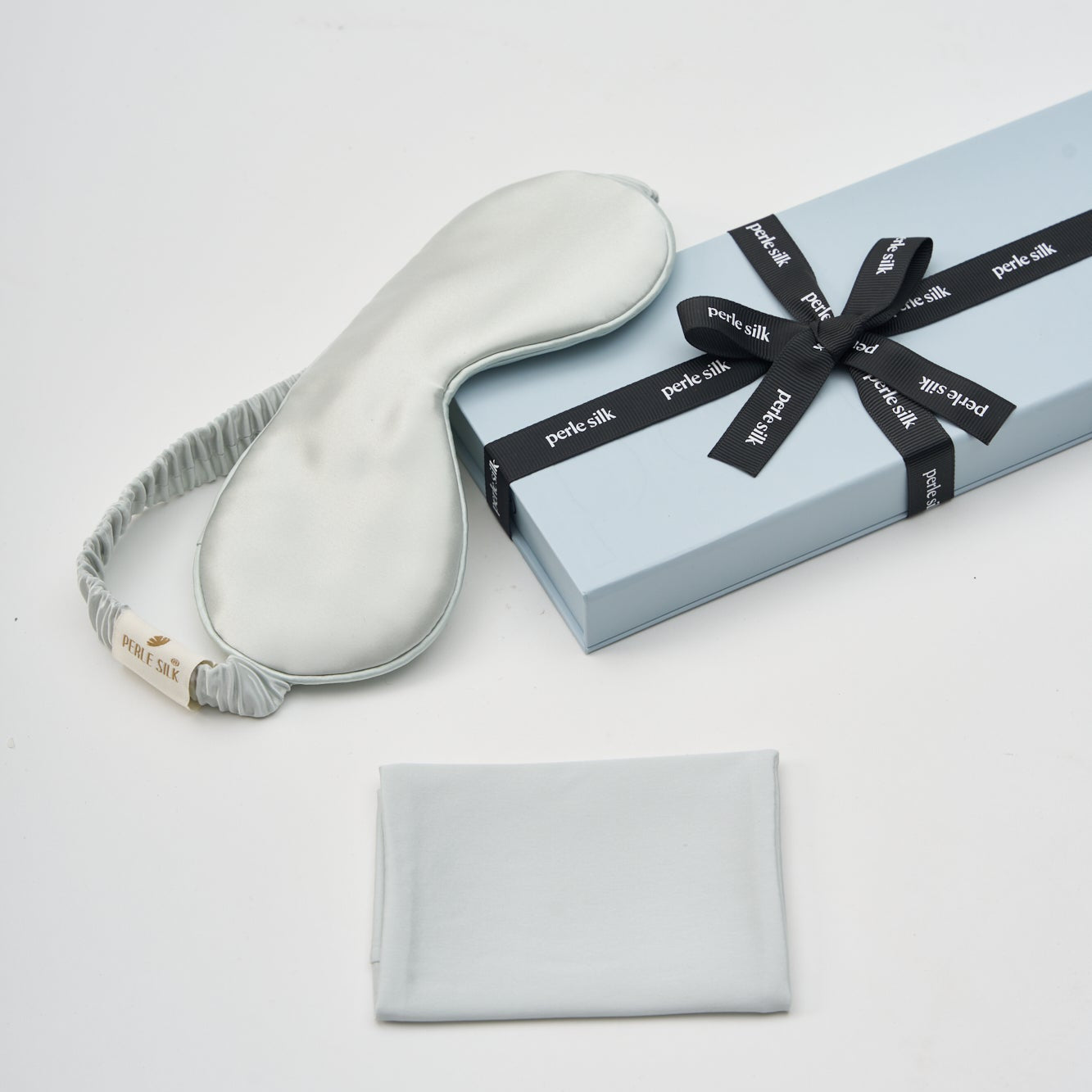 mist silk sleep mask with a black ribbon on a white background